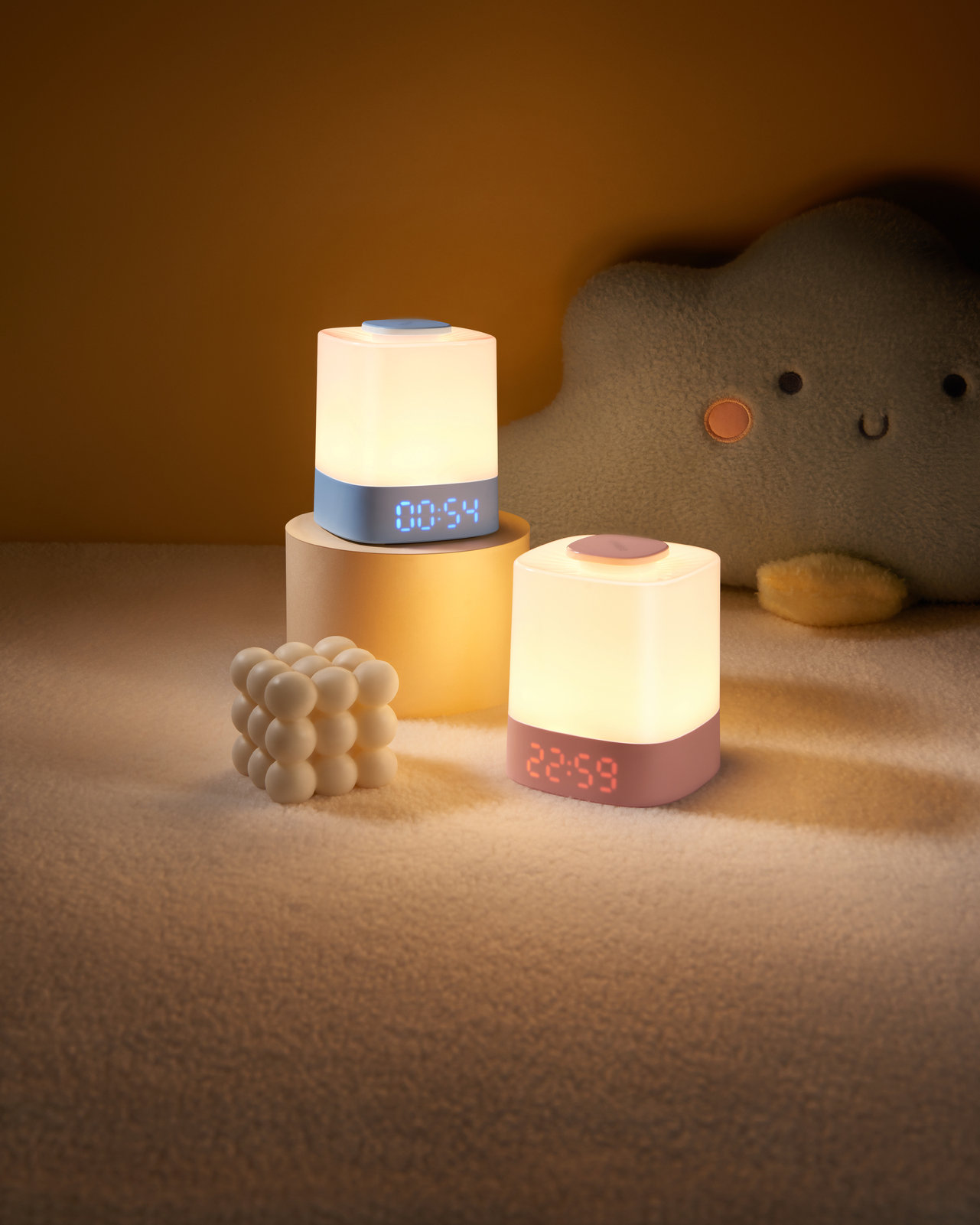 Two rechargeable bedside lamps lit in soft light on a night table