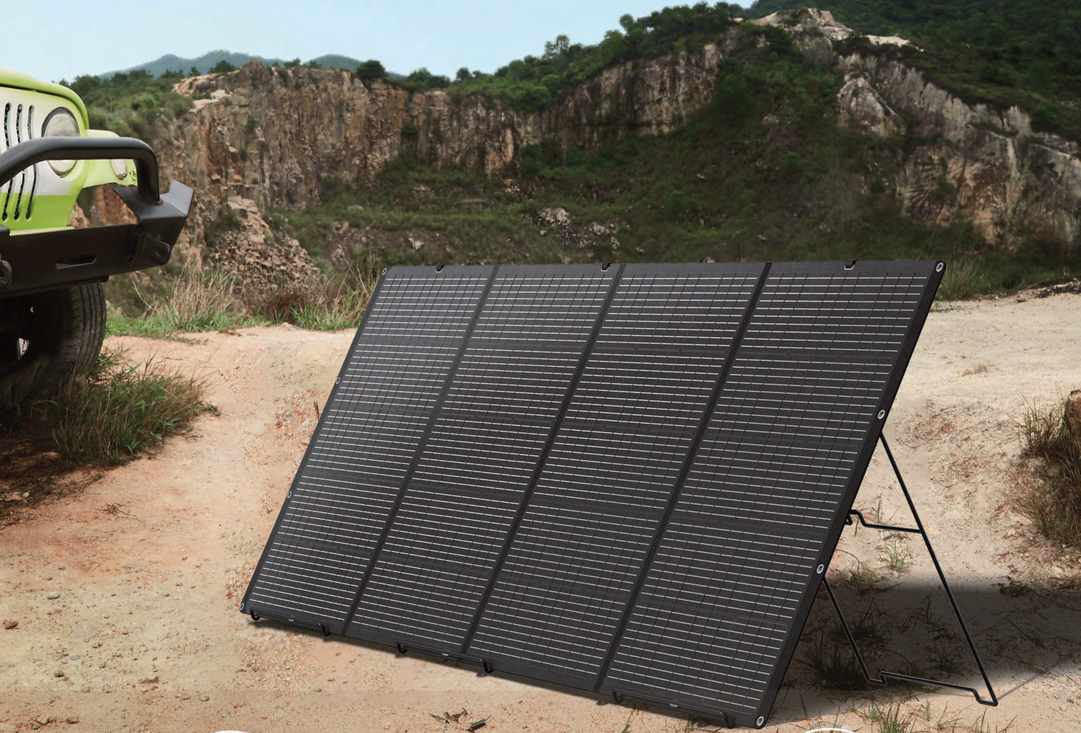 Foldable solar panel opened on its stand, outdoors next to a vehicle